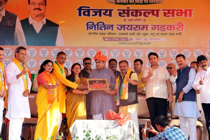 Union Minister, Nitin Gadkari being presented portrait of Mata Vaishno Devi by BJP leaders at an election rally at Jammu on Thursday. -Excelsior/Rakesh