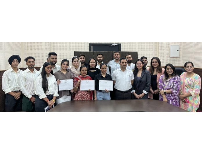 Students of ARC Hospitality Institute displaying their certificates while posing with guest and faculty members.