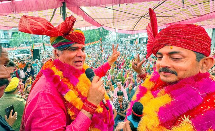 BJP president, Ravinder Raina and party candidate for Udhampur East, R S Pathania at an election rally on Sunday.