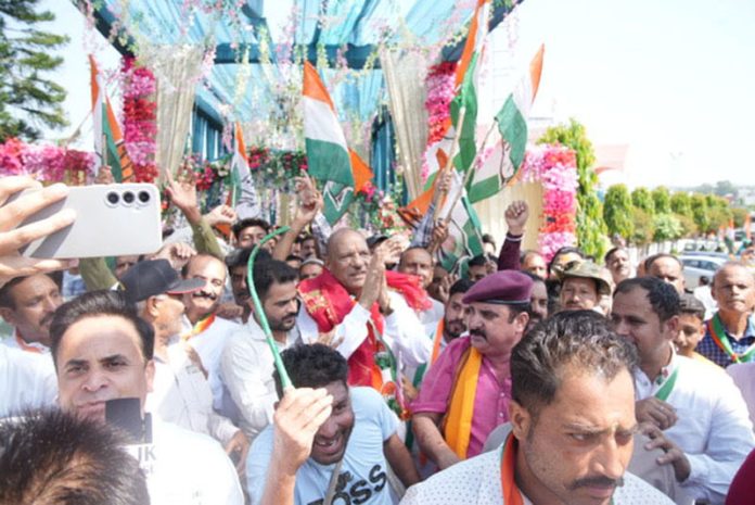 Cong candidate Mula Ram along with his supporters during a rally in Jammu on Sunday.