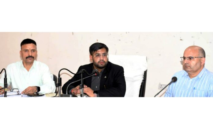 DEO Rajouri chairing a meeting.