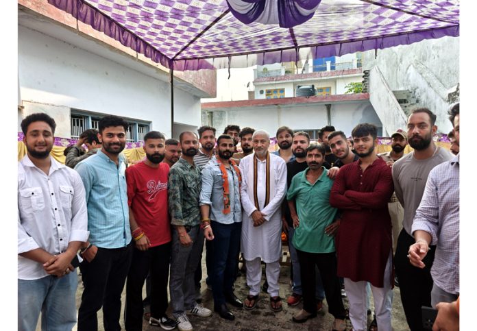 BJP nominee for Jammu North constituency, Sham Lal Sharma posing with his supporters after a meeting.