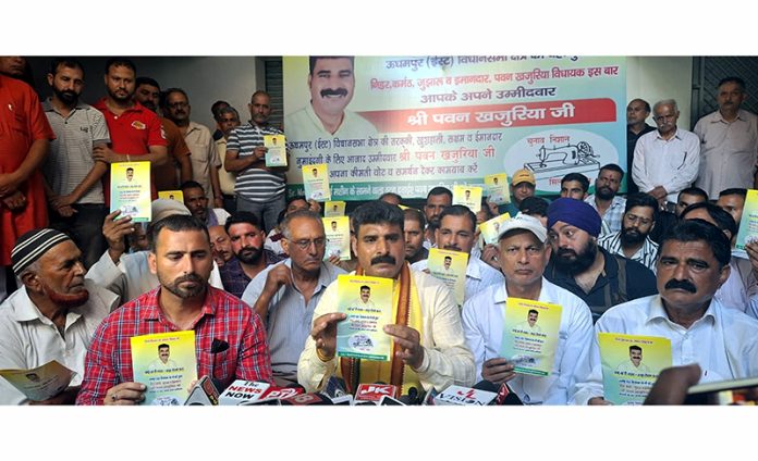 Independent candidate from Udhampur East, Pawan Khajuria releasing his pledge letter at a press conference at Udhampur on Wednesday.