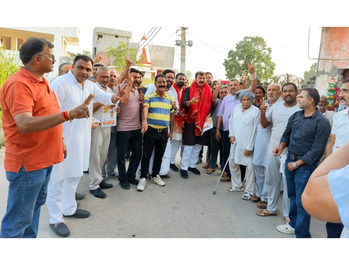 BJP candidate for Jammu West, Arvind Gupta posing for a photograph with supporters during campaigning.