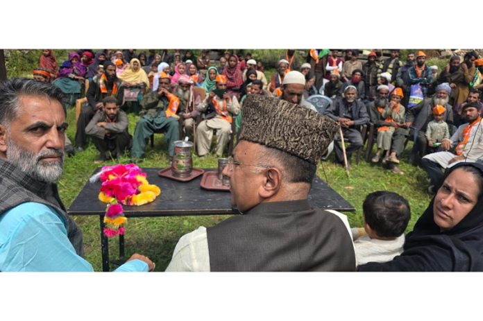 BJP MP Gulam Ali Khatana addressing an election meeting along with party candidate for Inderwal, Haji Tariq Ahmed Keen at Kither on Sunday.