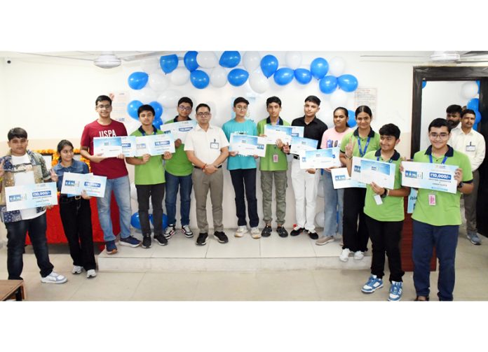 The winners of ‘U and Me’ exams posing with their vouchers in Jammu on Sunday.