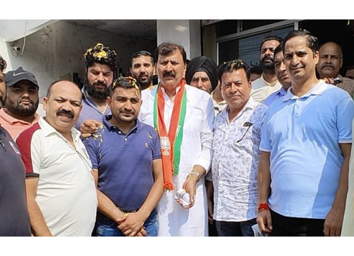 Arvind Gupta, contesting candidate from Jammu West posing along with the people on Thursday.