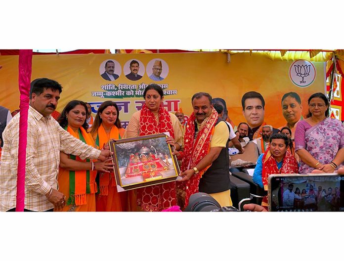 Former Union Minister and senior BJP leader Smriti Irani being presented the portrait of Mata Vaishno Devi during BJP rally at Bahu Fort by party candidate,Vikram Randhawa and other leaders.