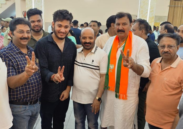 BJP candidate for Jammu West, Arvind Gupta along with former Minister, Bali Bhagat during campaigning on Tuesday.