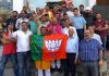 Traders of various markets of Jammu East welcoming BJP candidate, Yudhvir Sethi at a function on Wednesday.