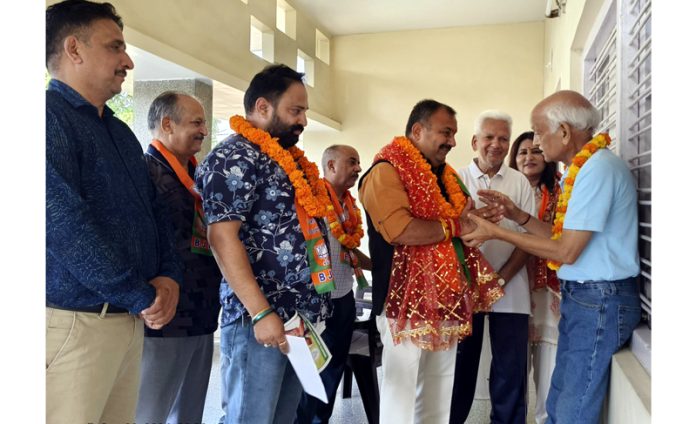 BJP candidate Vikram Randhawa during a door to door campaign in Bahu Assembly segment on Friday.