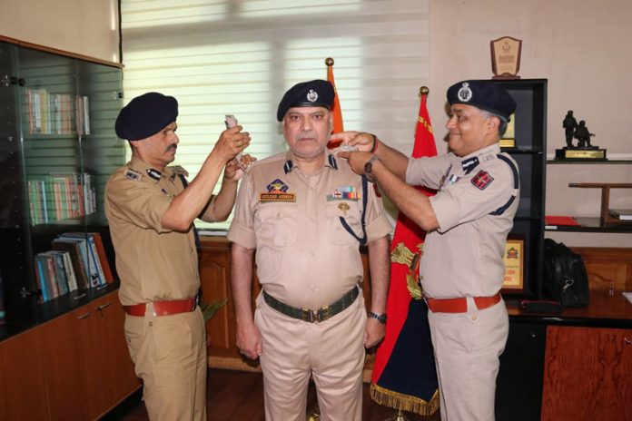 DGP RR Swain pinning rank to SSP Gulzar Ahmad Shah in Srinagar on Thursday.