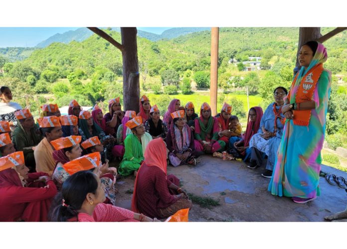 BJP leader Ratna Kumari addressing a meeting of self help groups in Ramnagar.