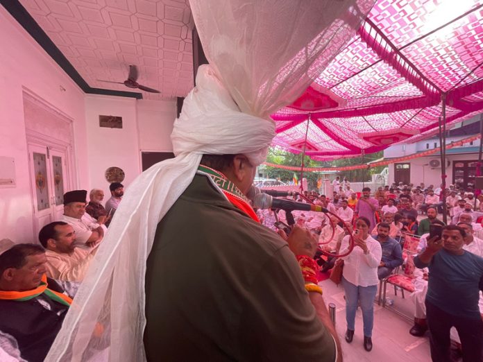 BJP leader Vikram Randhawa addressing a gathering in Bahu Assembly constituency on Thursday.