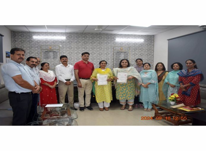 Principals of GDC Kathua and LBS College of Education display copies of MoU signed between the two institutes.