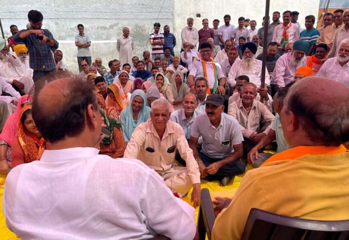 BJP leader Dr. Devinder Kumar Manyal conducting door to door campaign in Ramgarh on Friday.