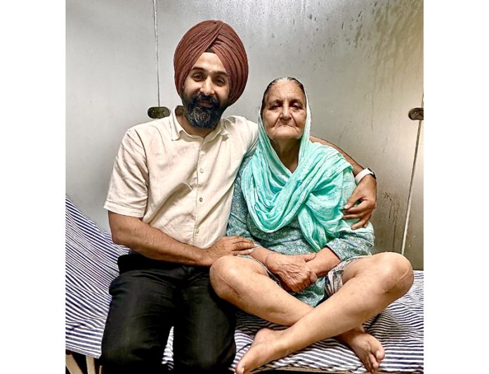 Dr Ranjit Singh posing with a patient on whom he performed knee replacement surgery.