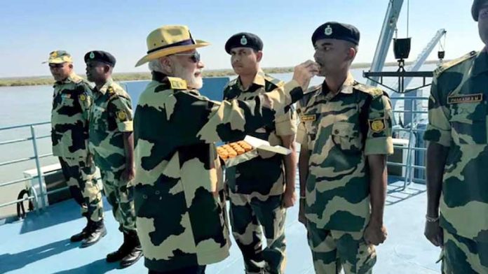 PM Narendra Modi offering sweets to an Army officer at Sir Creek in Gujarat’s Kutch district on Thursday.