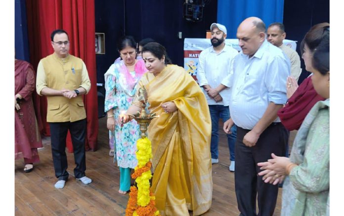 Jt Dir JKSCERT Prof Dr Sindhu Kapoor lighting the traditional lamp during a function in Jammu on Tuesday.