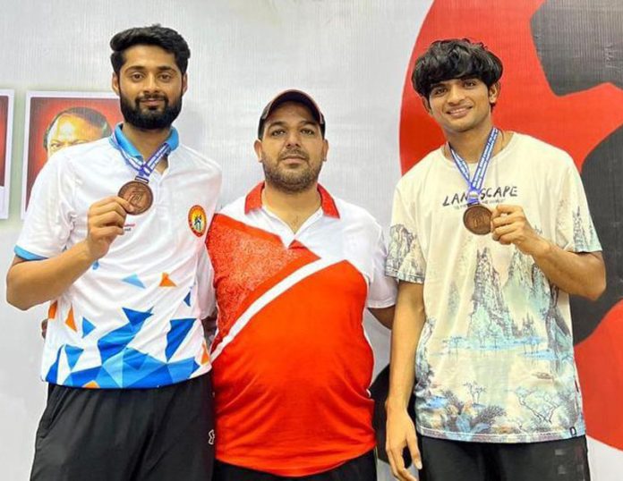 Taekwondo athletes posing with medals.