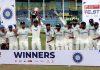 Indian cricket team players pose for photographers with the trophy after winning the second test cricket match against Bangladesh at Green Park Stadium in Kanpur on Tuesday. (UNI)