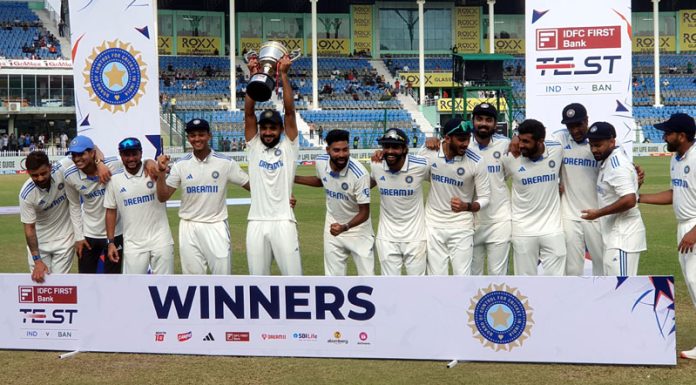 Indian cricket team players pose for photographers with the trophy after winning the second test cricket match against Bangladesh at Green Park Stadium in Kanpur on Tuesday. (UNI)