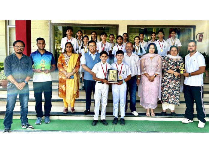 Netball players posing along with trophy and dignitaries.