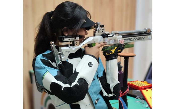 Shooting champion Raveena Jangid aiming at target.