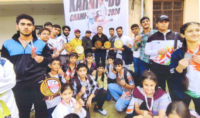 Players of J&K Karate team display medals they won at a Championship in Pathankot.