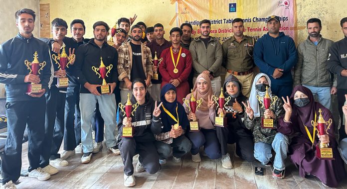 Participating players along with others pose for a group photograph on the conclusion of Bandipora District Table Tennis Championship.