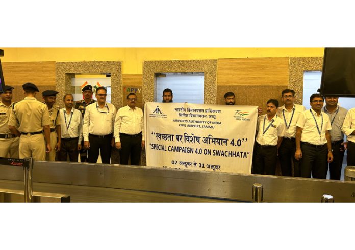 AAI and CISF personnel during the cleanliness drive at Jammu Airport on Monday.