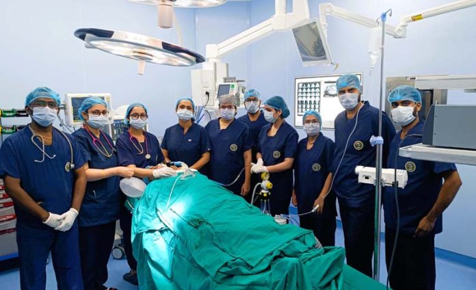 Dr Amanjot Kaur (Assistant Prof, Oral and Maxillofacial Surgery, AIIMS Jammu) and his team posing together after conducting a surgery.