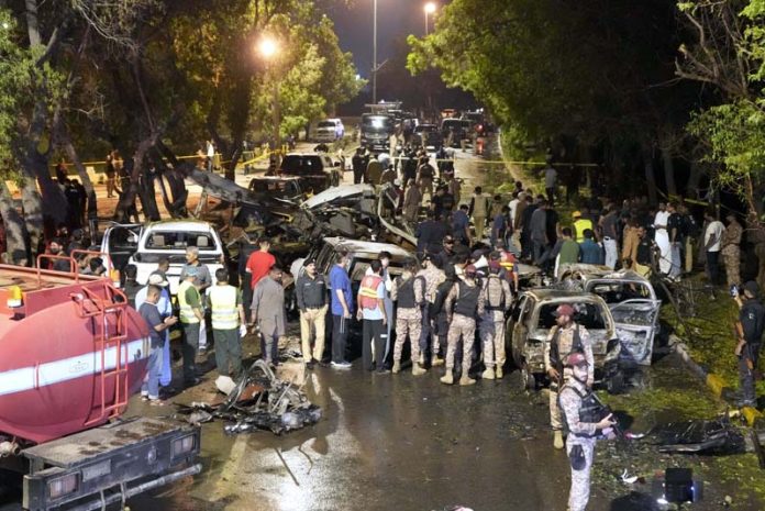 Security officials examine the site of an explosion outside the Karachi airport.