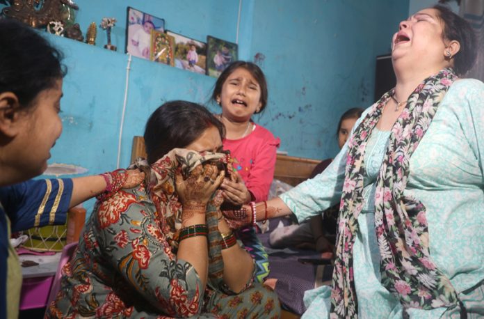 Family members of Shashi Abrol wailing over his death at their residence in Talab Tillo, Jammu on Monday morning. Another pic on page 11. -Excelsior/Rakesh