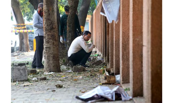 Forensic experts collect samples after a blast near the CRPF school in Delhi's Prashant Vihar on Sunday.