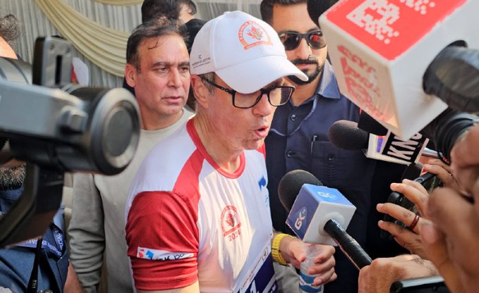 Chief Minister Omar Abdullah speaking with media persons after running half marathon in Srinagar on Sunday. - Excelsior/Shakeel