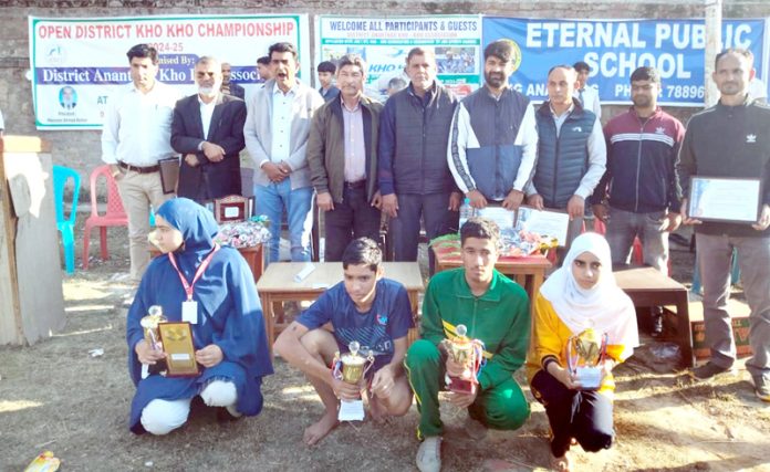 Players posing along with trophies and dignitaries.