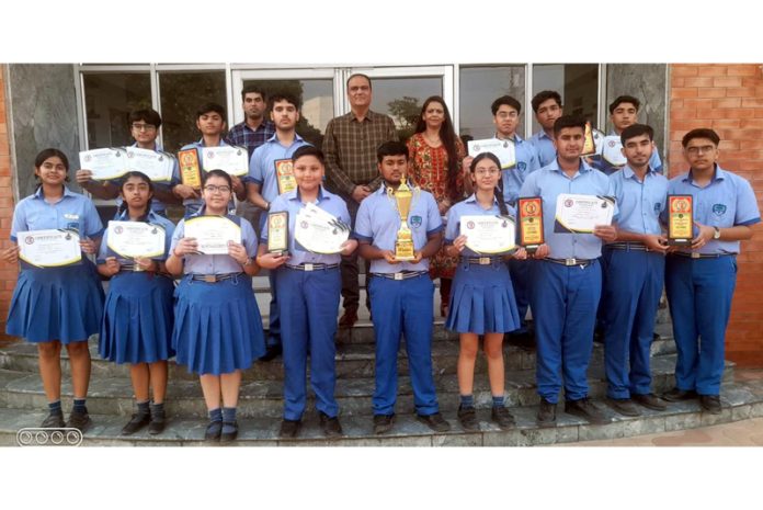 Heritage students posing along with certificates and trophy.