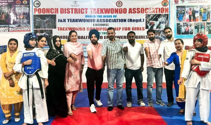 Tehsildar Haveli, Azhar Majeed posing along with Taekwondo girls during opening ceremony at Poonch.