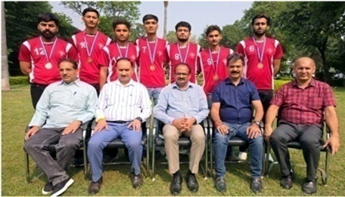 Volleyball players of GGM Science College posing along with college management.