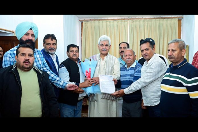 Delegation of All J&K Transport Welfare Association presenting bouquet to LG Manoj Sinha.