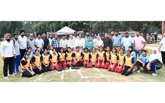 Softball teams posing along with dignitaries during a competition at Jammu.