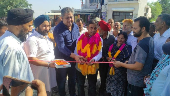 MLA Kathua, Dr Bharat Bhushan cutting ribbon to dedicate a road to the public in Kathua.