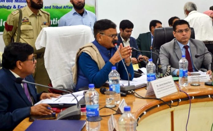 Minister Javed Rana chairing a meeting.