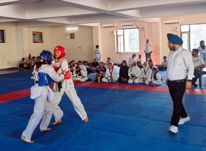 Taekwondo players in action during a match in Jammu on Monday.