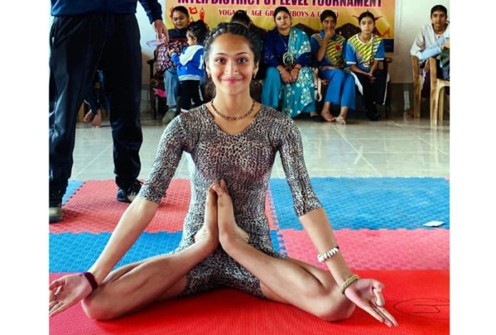 A girl displaying Yoga skills during an event at Baramulla.