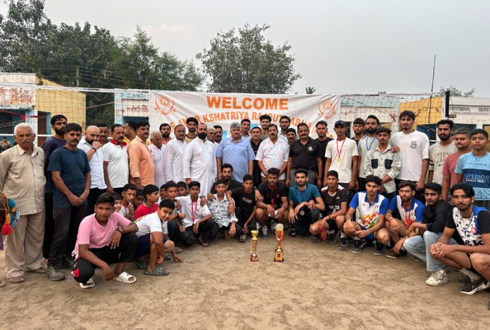 Volleyball players posing along with dignitaries.