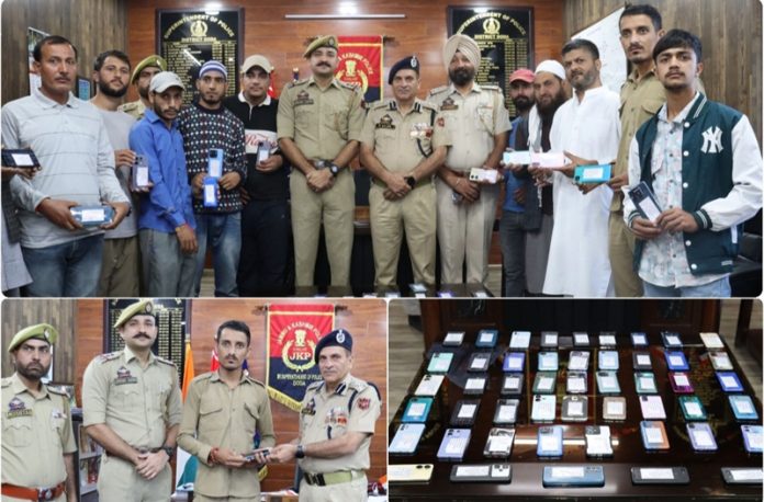 Owners of lost phones posing for a group photograph after getting the same from Police after recovery. -Excelsior/Tilak Raj