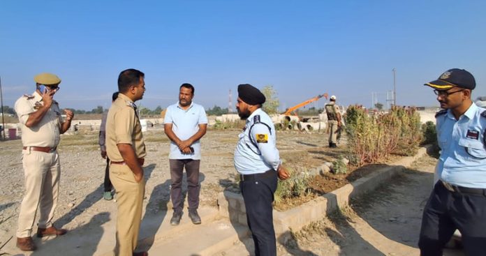 SSP Kathua Shobhit Saksena interacting with security guards at a construction site in Bhagthali.