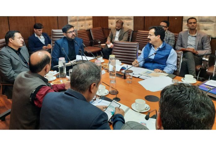 Minister Satish Sharma chairing a meeting.